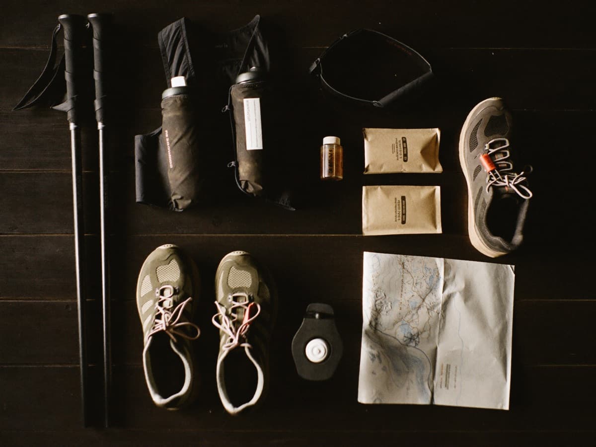 Race kit laid out: watch, gels, a printed course profile, a headlamp