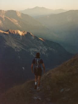 A runner on a mountain trail at first light